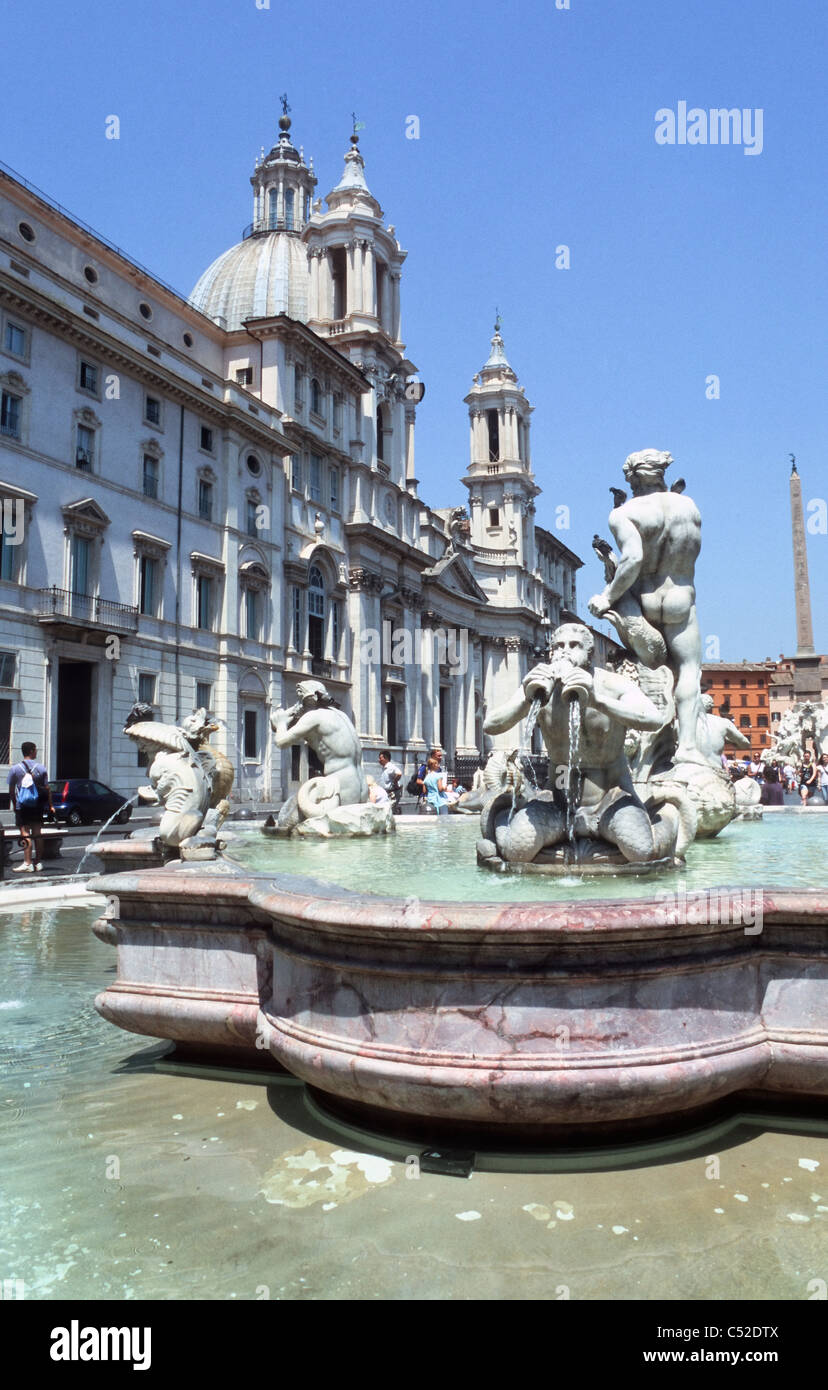 Fontana del Moro, background with church Sant'Agnese in Agone and Fontana dei Fiumi, Piazza Navona, Rome, Latium, Italy Stock Photo