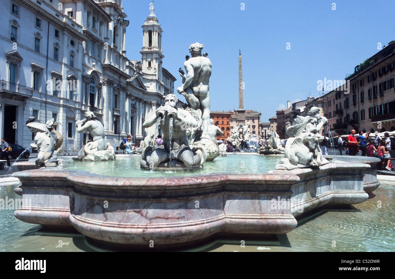 Fontana del Moro, background with church Sant'Agnese in Agone and Fontana dei Fiumi, Piazza Navona, Rome, Latium, Italy Stock Photo