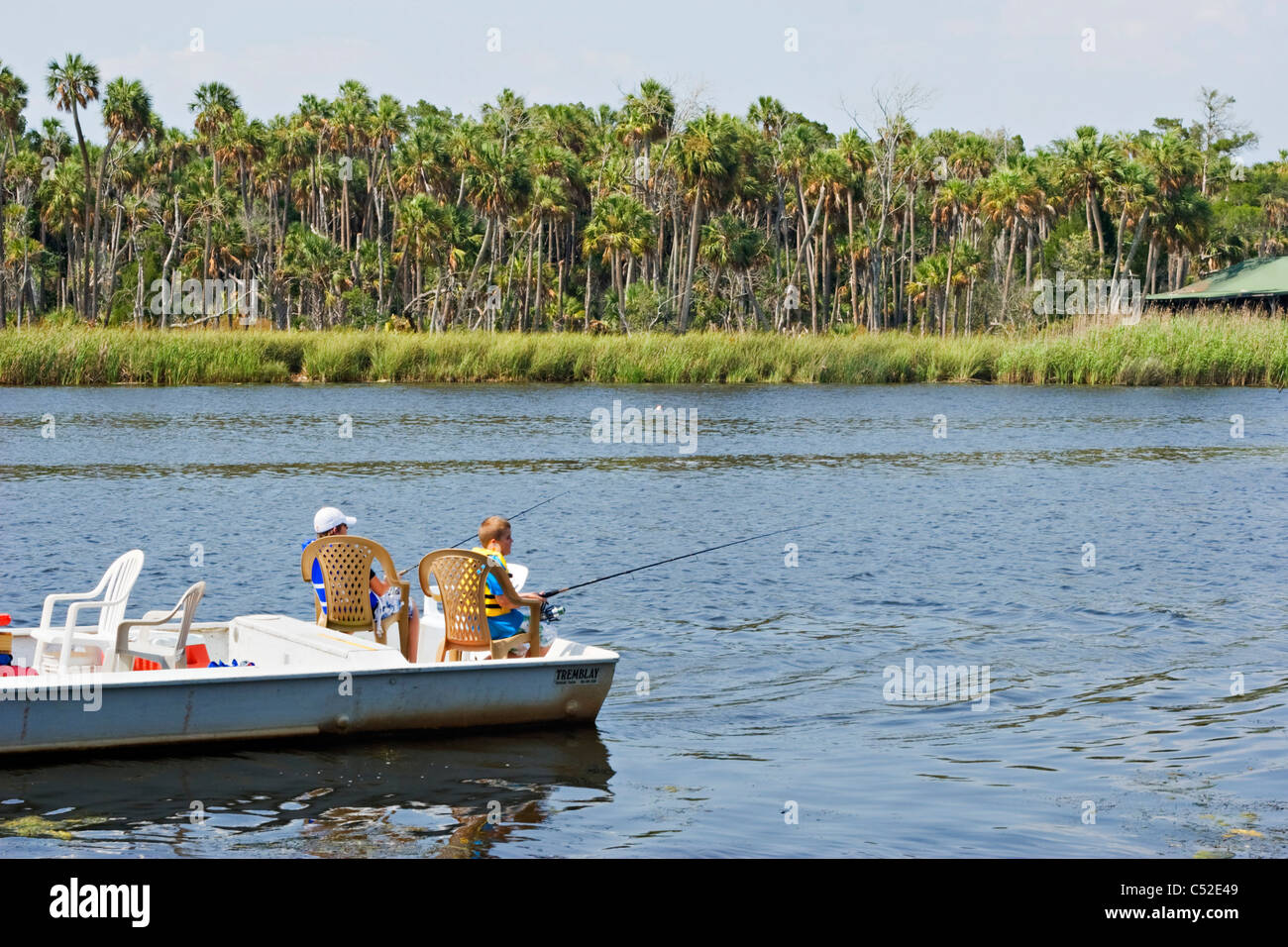 Two young boys fishing from boat in Florida gulf coast Chassahowitzka river Stock Photo