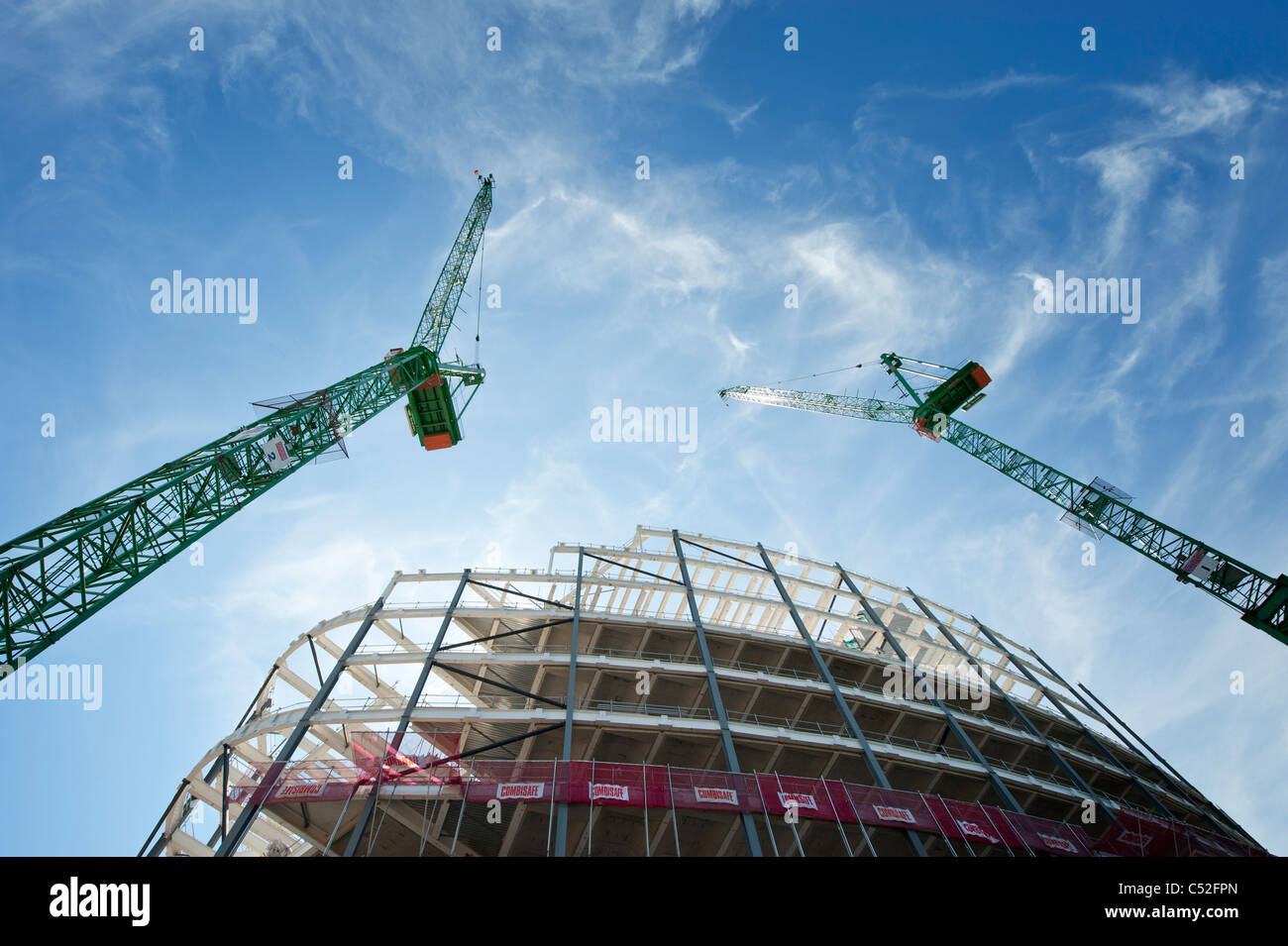 Two cranes tower over the construction site of a new Co-op building in Manchester. Stock Photo