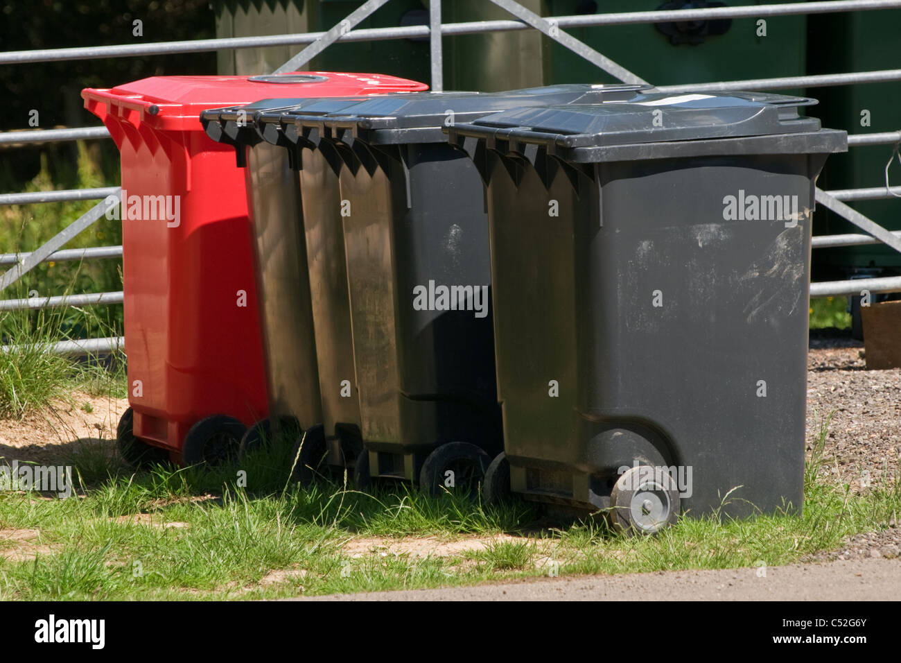Five large recycle wheelie bins View from the side. Close up Stock