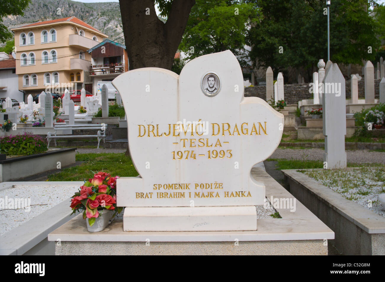 Grave of a young man who died during the war of 1990s in Muslim graveyard Mostar city Bosnia and Herzegovina Europe Stock Photo