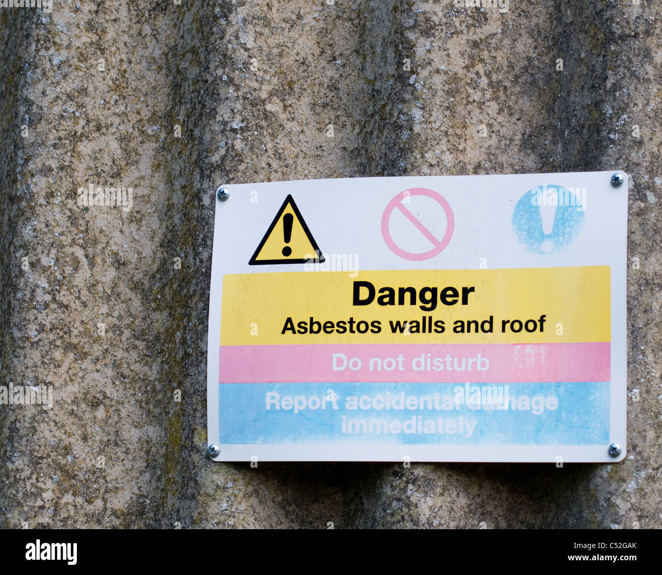 Danger Asbestos walls and roof sign, do not disturb, report accidental damage immediately Stock Photo