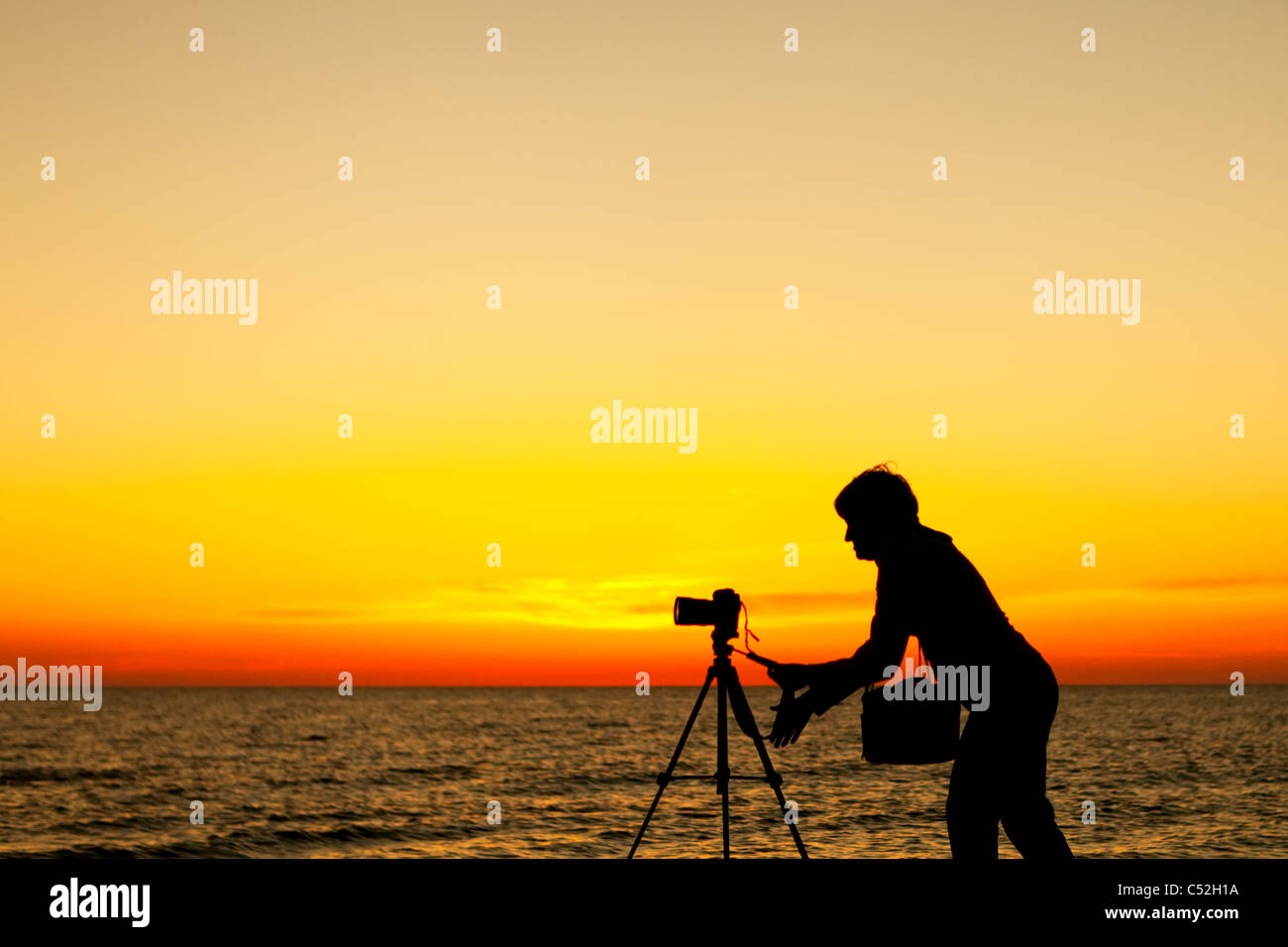 Photogrpher working at sunset Stock Photo