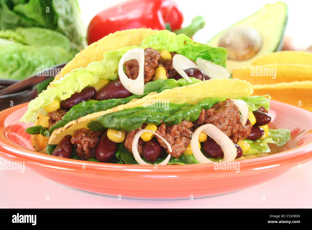 Mexican tacos with ground beef, lettuce, red kidney beans and corn on a