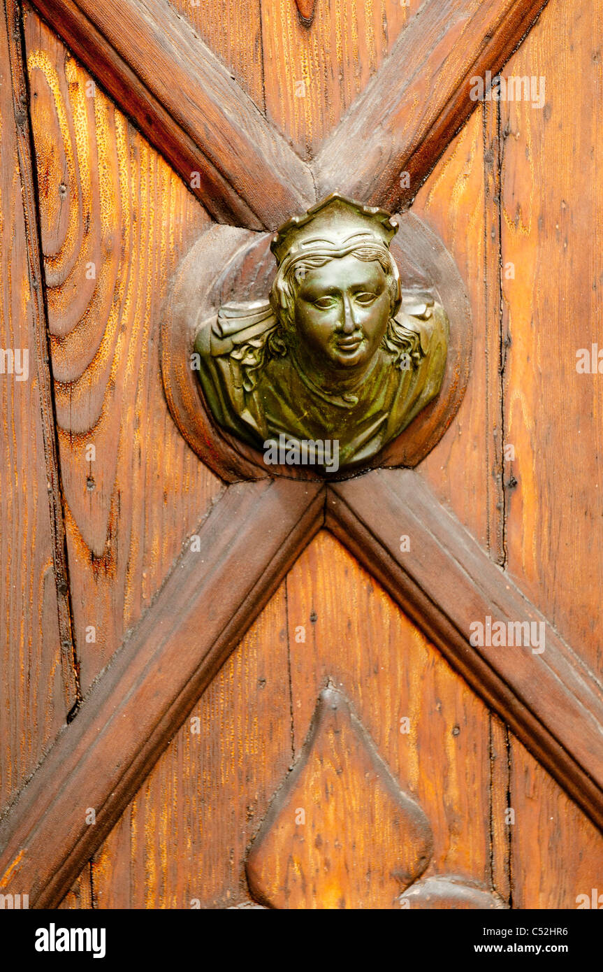 Fancy ladies head door Knob on carved door in Venice, Italy Stock Photo