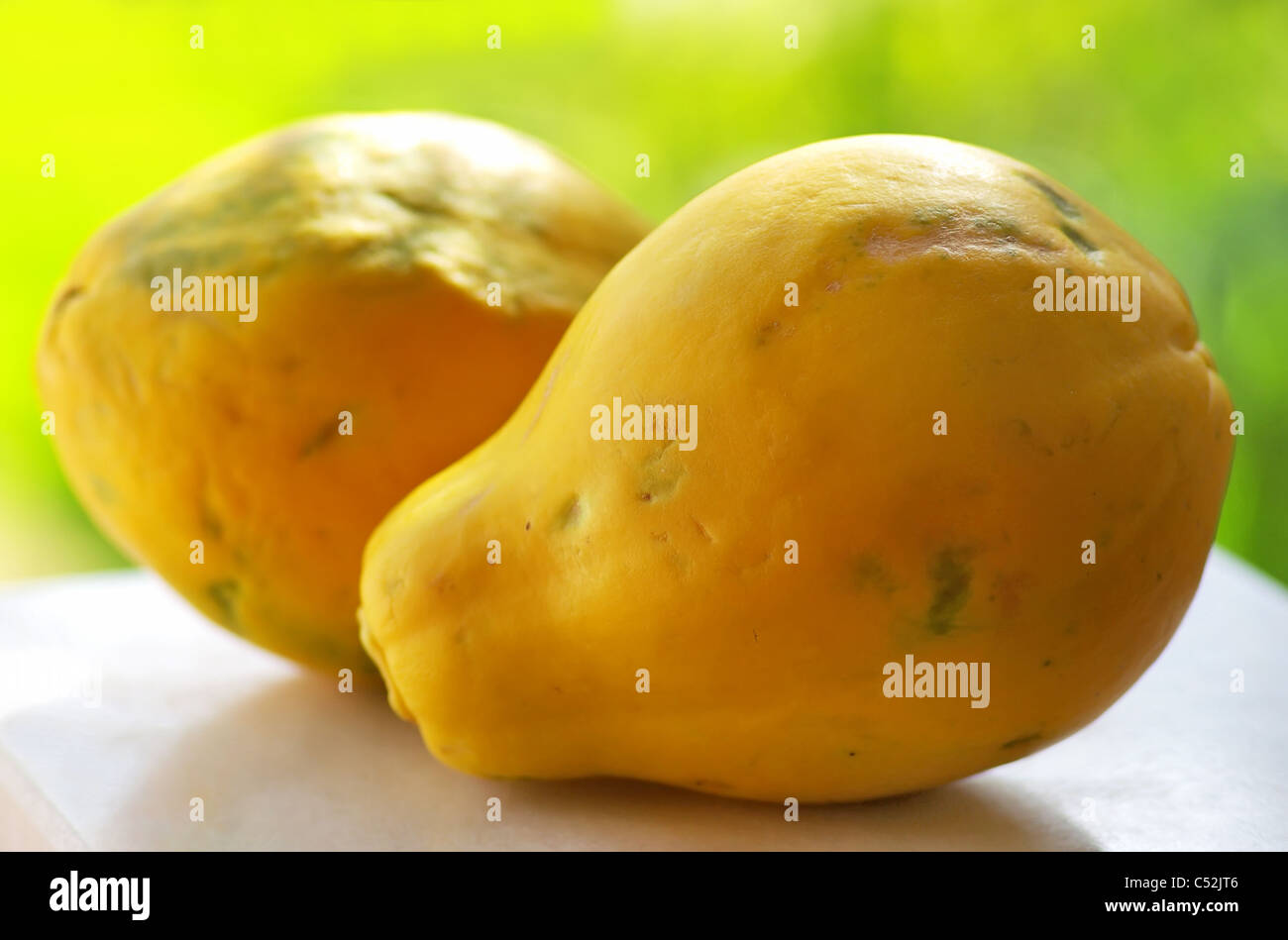 papayas on a green background Stock Photo Alamy