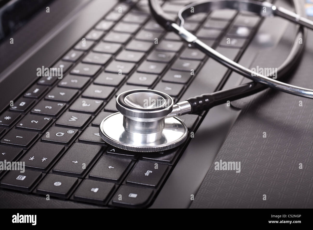 Close-up of stethoscope on laptop keyboard Stock Photo - Alamy