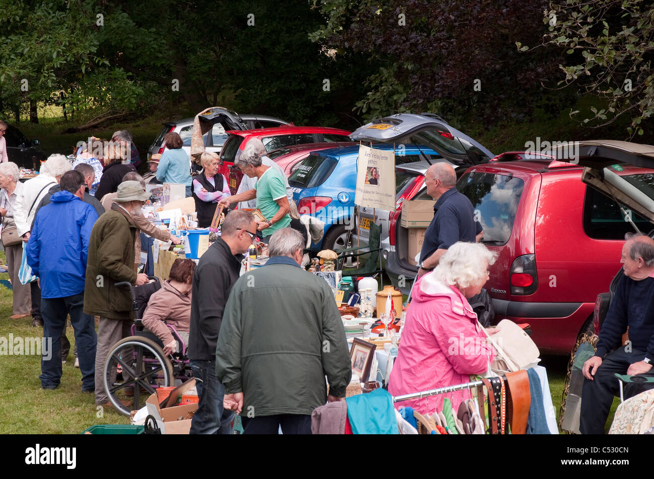 People shopping at a car boot sale on a summers day in England Stock