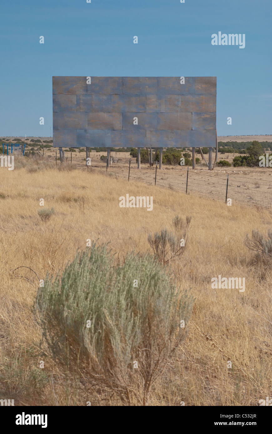 An empty billboard awaits a creative advertisement on the side of the road in rural New Mexico. Stock Photo