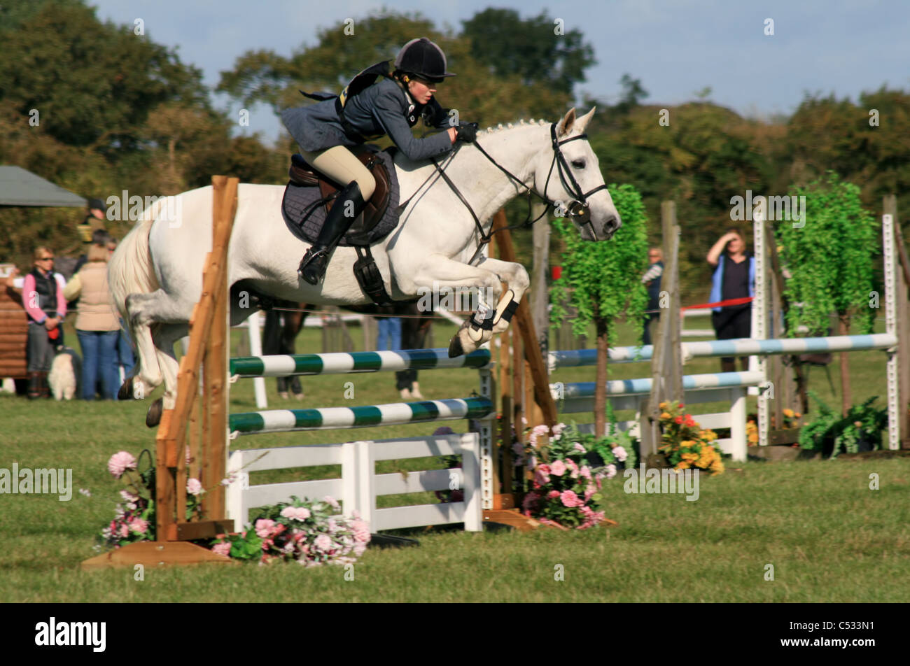 Young lady show jumping Somerford Park at eventing two day horse trial Cheshire England September 2009 Stock Photo