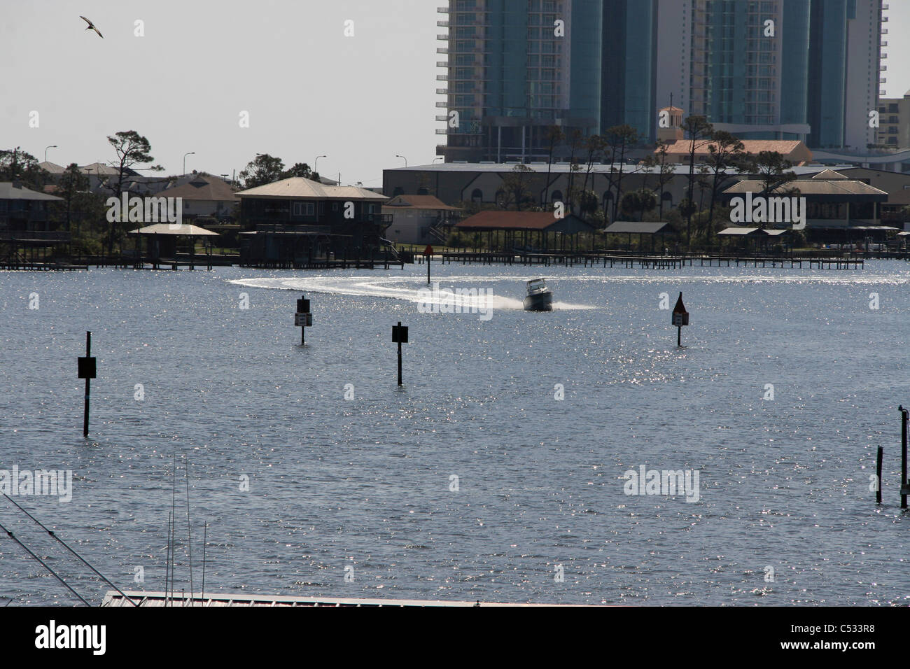 Orange beach alabama intercoastal waterway with boat gliding through the water Stock Photo