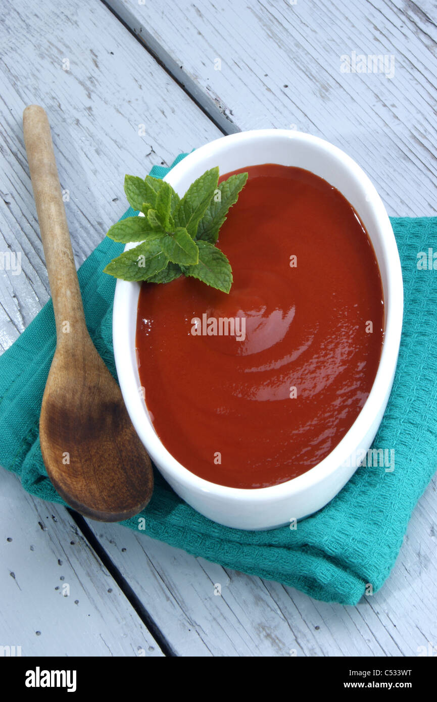View of fresh tomato sauce with mint in a white bowl Stock Photo - Alamy