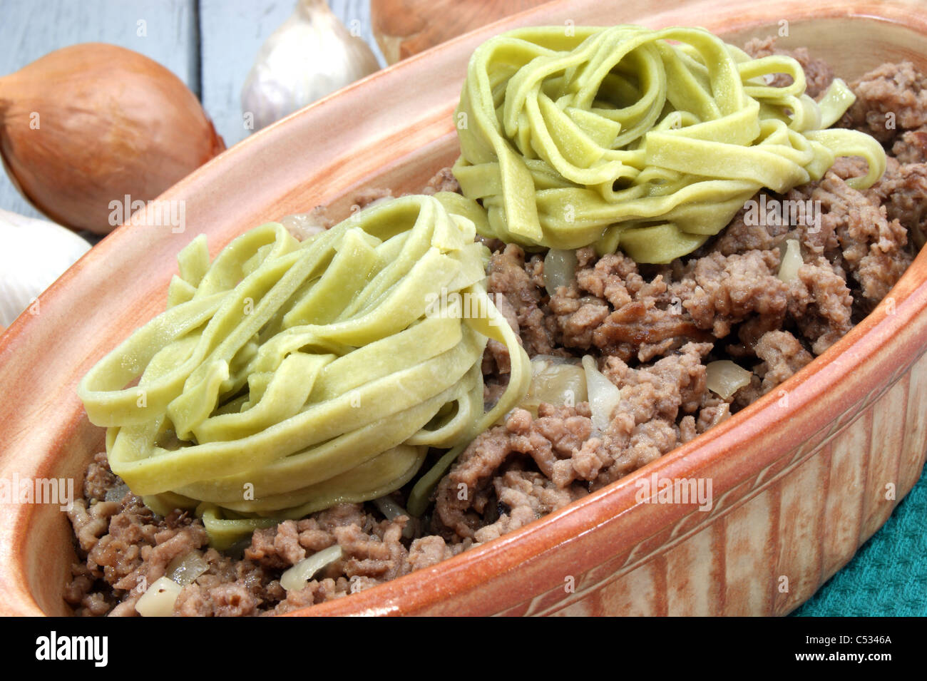 minced meat with homemade green ribbon noodles Stock Photo - Alamy