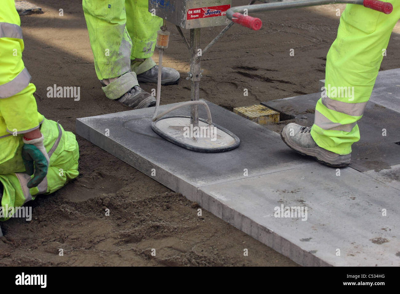 Paving slabs being laid in a street in London using a vacuum lifter
