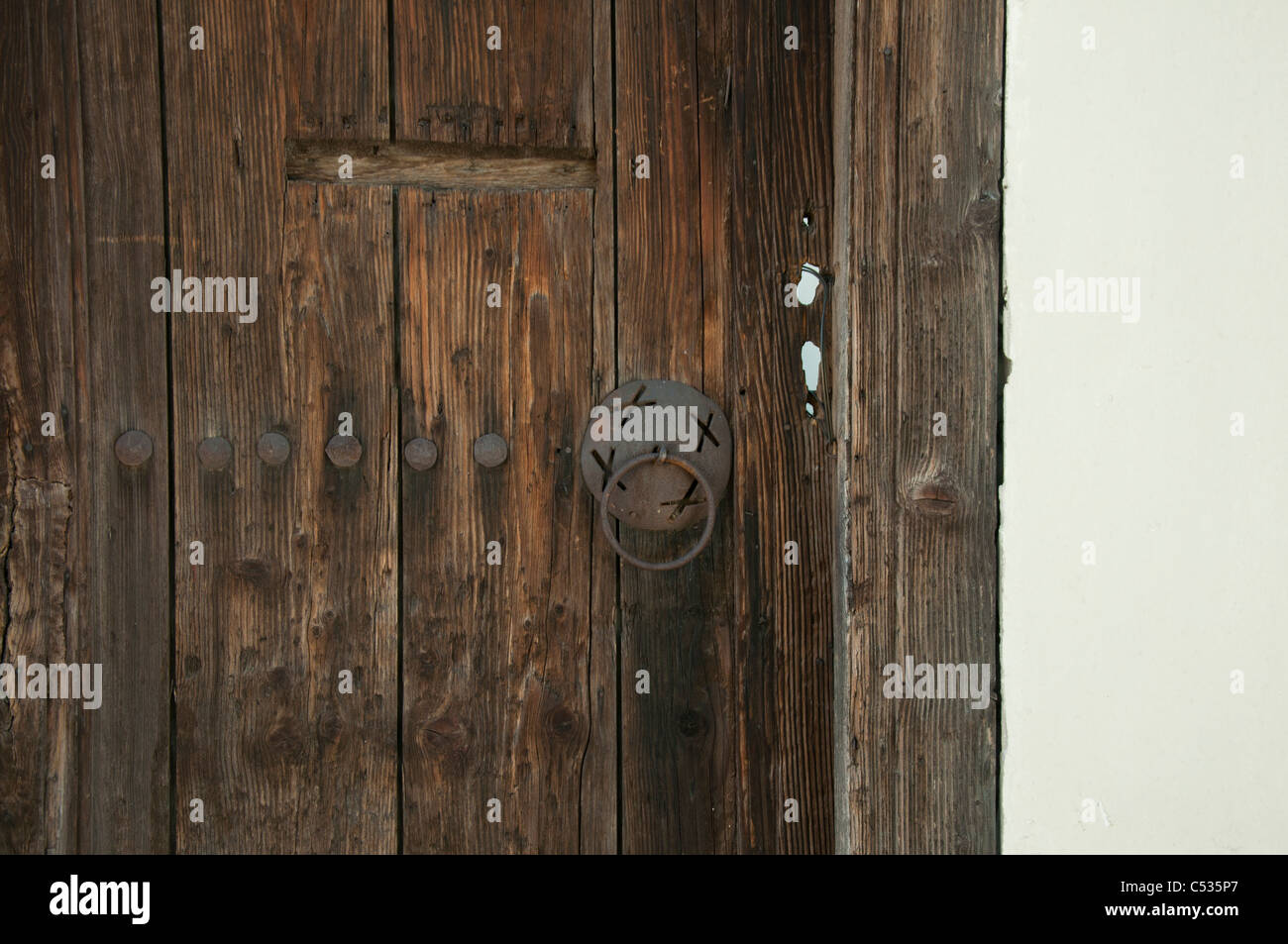 Old brown wooden door. White wall Stock Photo Alamy