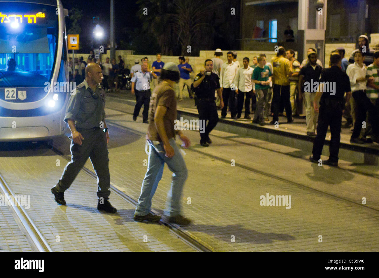 In a game of 'cat and mouse' police chase away youth blocking traffic ...