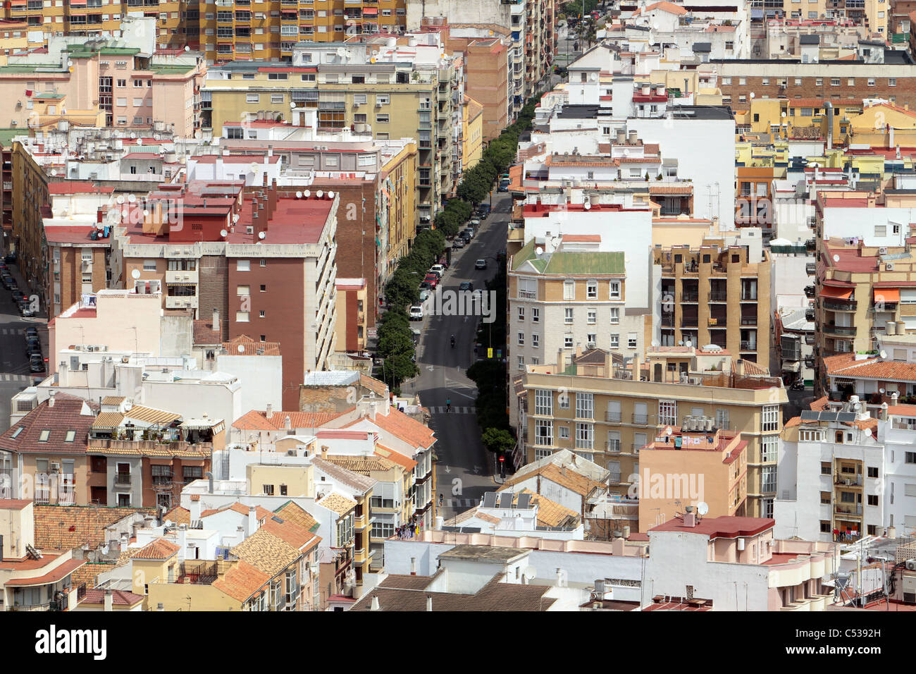 City of Malaga Spain the Mediterranean Sea port showing downtown with tree lined street, and high rise apartments,congested area Stock Photo