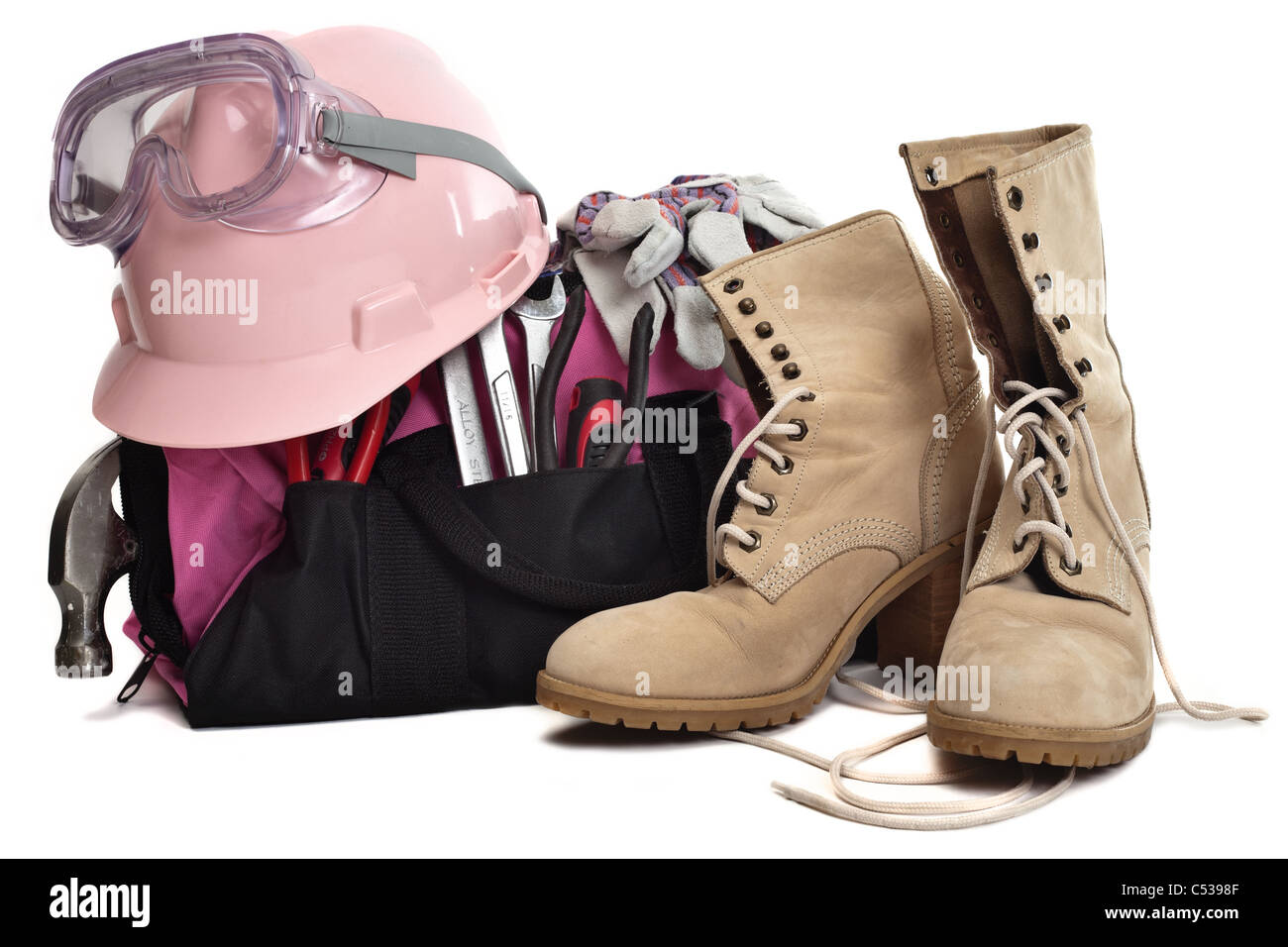 a woman's tool bag. tools, hard hat, goggles and boots. A pink tool bag and pink hard hat. Stock Photo