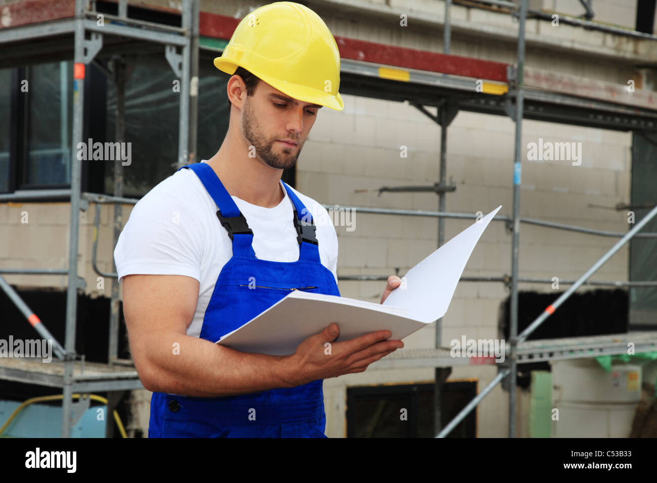 Manual worker on construction site during building inspection. Stock Photo
