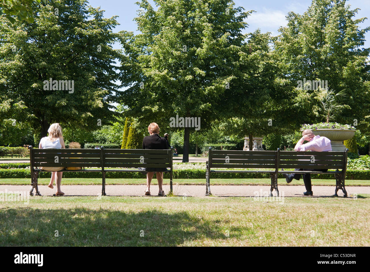 Lonely people sitting on a bench in the park Stock Photo