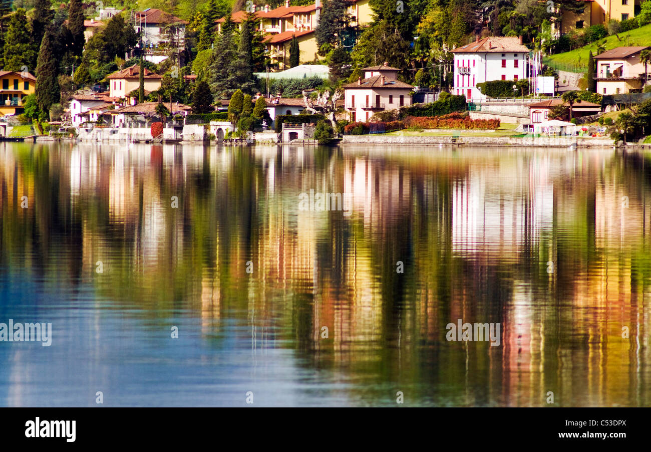Houses and villas reflected in Lake Lugano at Cima Stock Photo