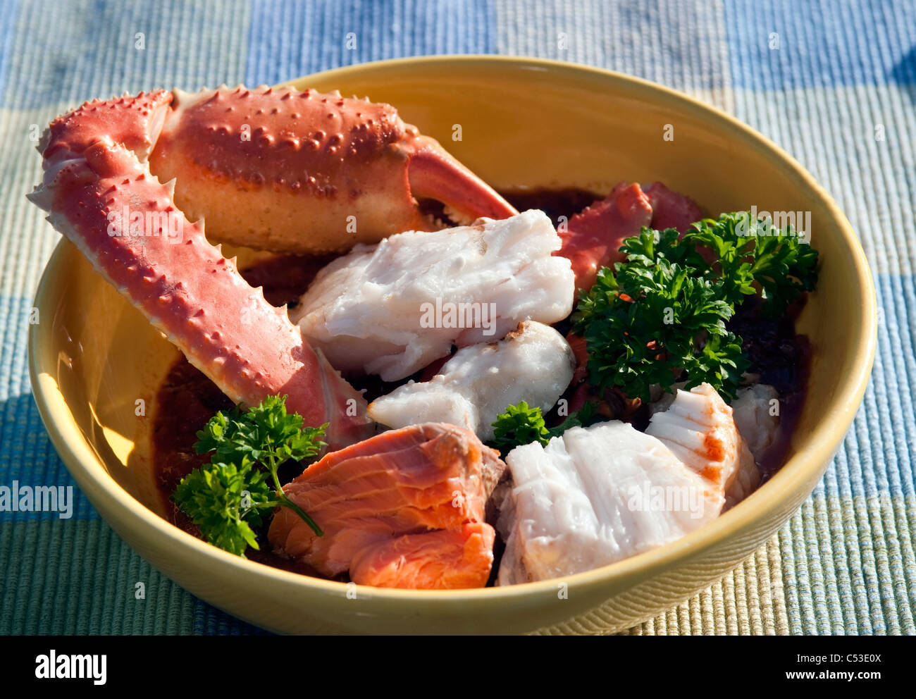 Close up view of Cioppino fish stew containing fresh Alaskan Tanner Crab, Smoked King Salmon, Halibut, and Rockfish, Alaska Stock Photo