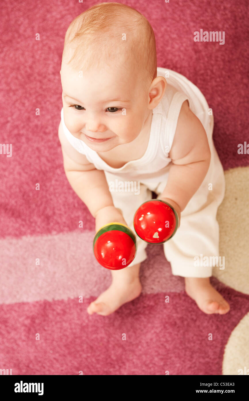 Cute baby girl s playing with toys in playroom Stock Photo - Alamy