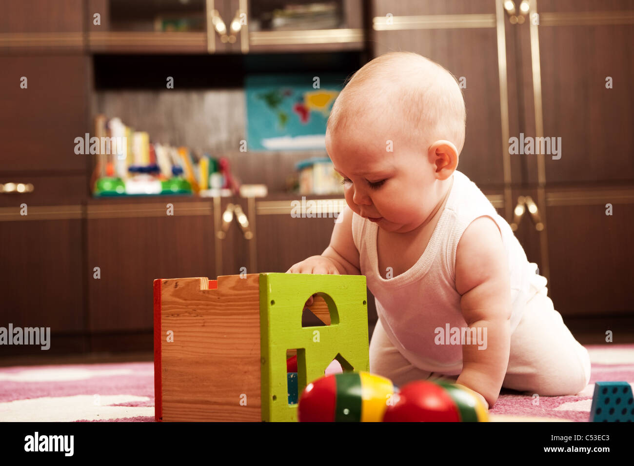 Cute baby girl s playing with toys in playroom Stock Photo - Alamy