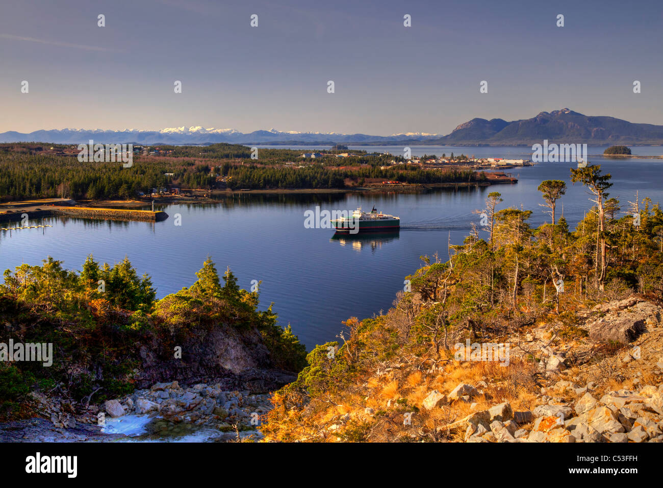 View of Metlakatla, Annette Island, and surrounding coastal area with a ferry in the foreground, Inside Passage, Alaska Stock Photo