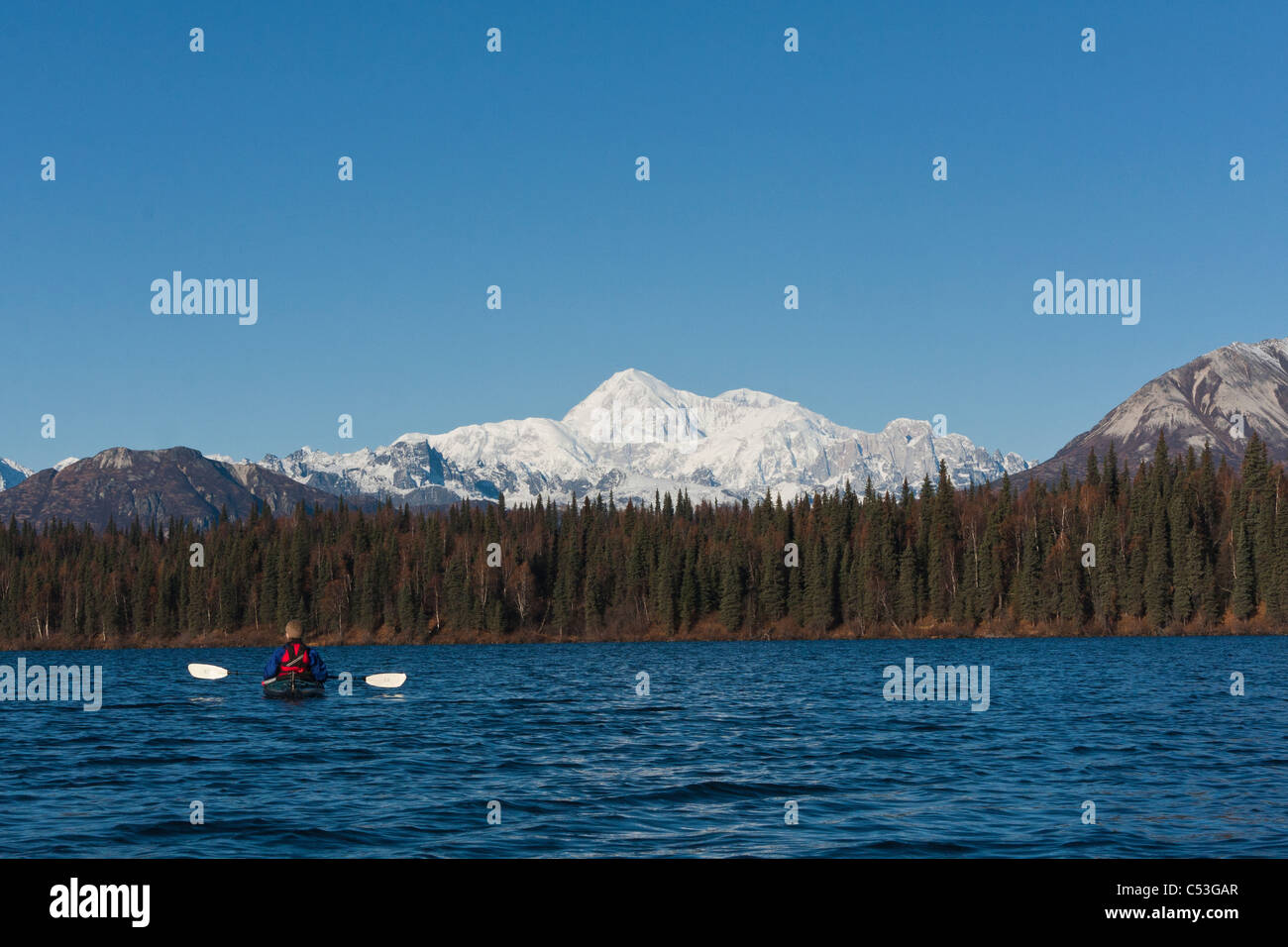 Woman kayaking in Byers Lake with scenic view of Mt. McKinley on a