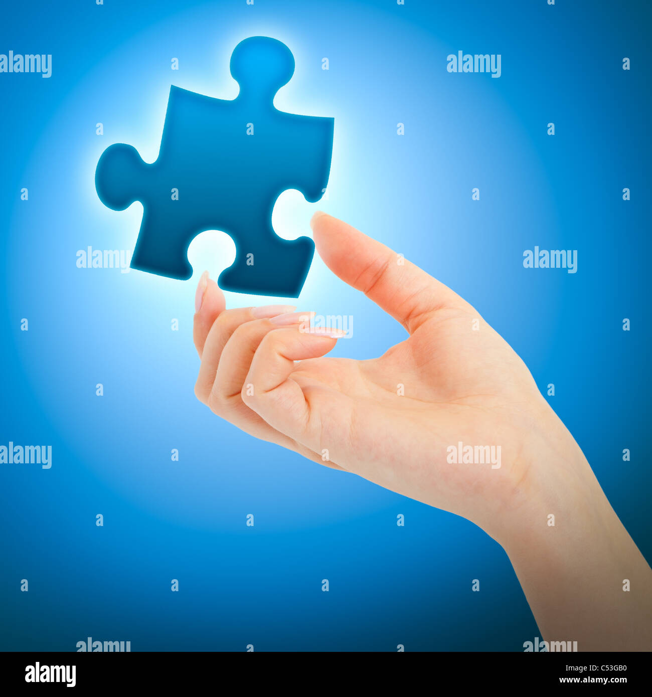 Womanish Hand With A Blue Shining Piece Of Puzzle On Blue Background Stock Photo Alamy