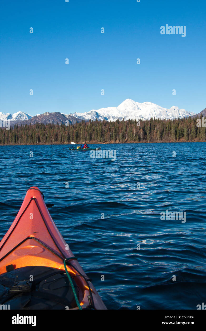 Young woman with long hair and hat kayaking in sun on lake Stock Photo -  Alamy