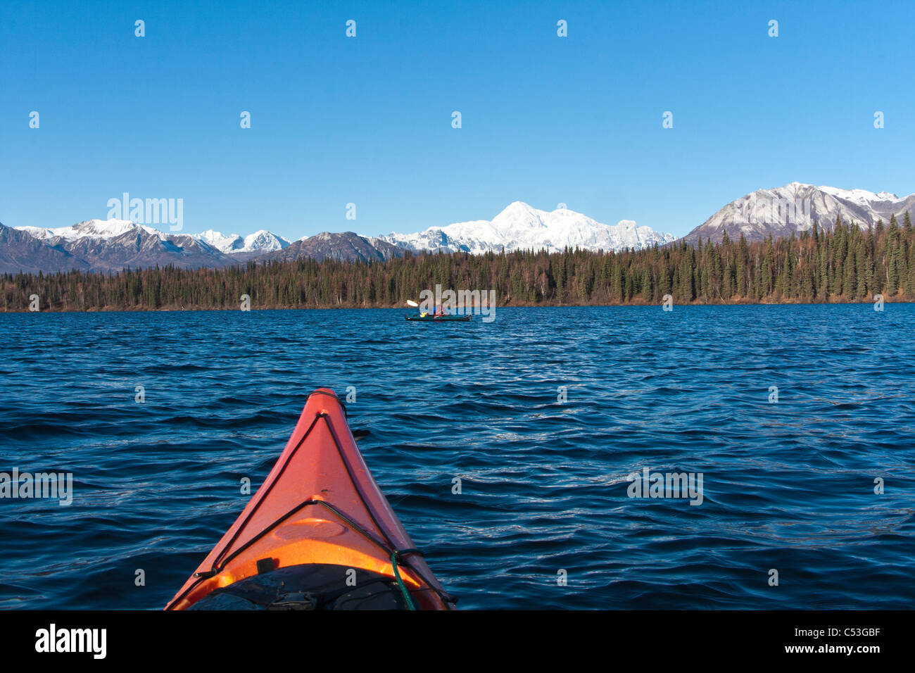 Woman kayaking in Byers Lake with scenic view of Mt. McKinley on a