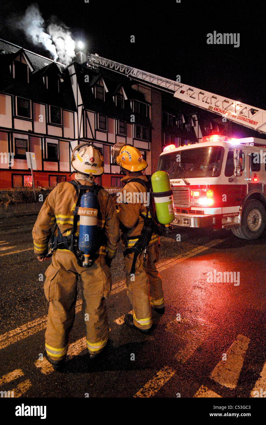 Members of the Anchorage Fire Department work during a cold winter