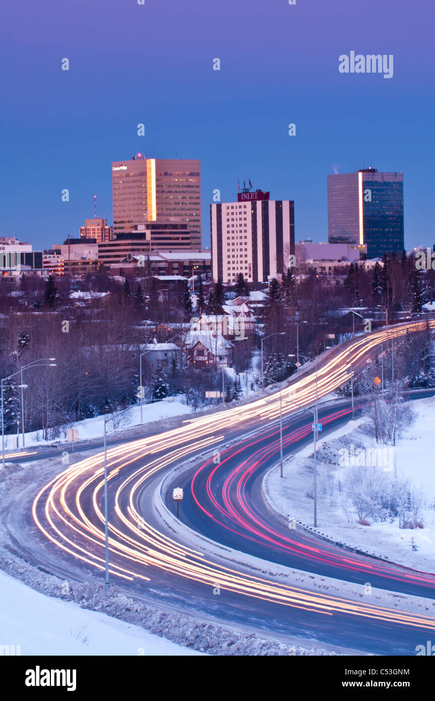 Traffic travels to and from downtown Anchorage during early evening along Minnesota Blvd., Southcentral Alaska, Winter Stock Photo