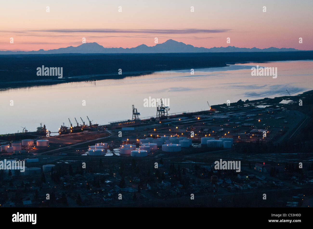 Aerial evening view of the Port of Anchorage with Mt. Foraker, Mt. Hunter and Mt. McKinley in the background, Alaska, Winter Stock Photo