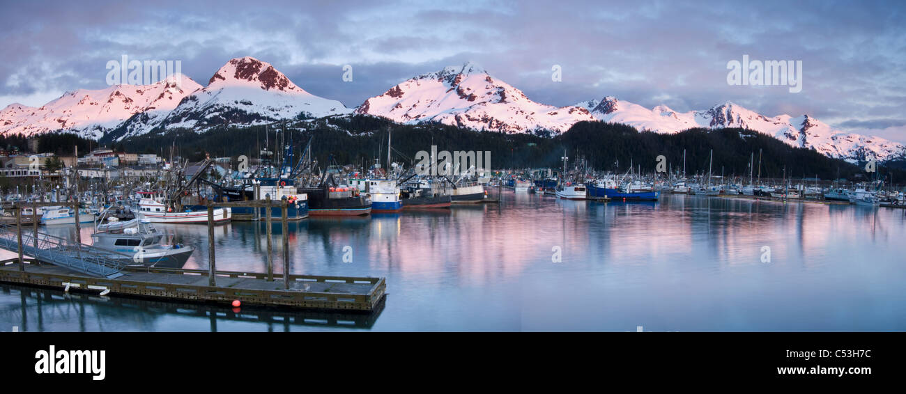 Evening alpenglow on the Chugach Mountains and Mt. Eyak behind the boat harbor at Cordova, Southcentral Alaska, Spring Stock Photo