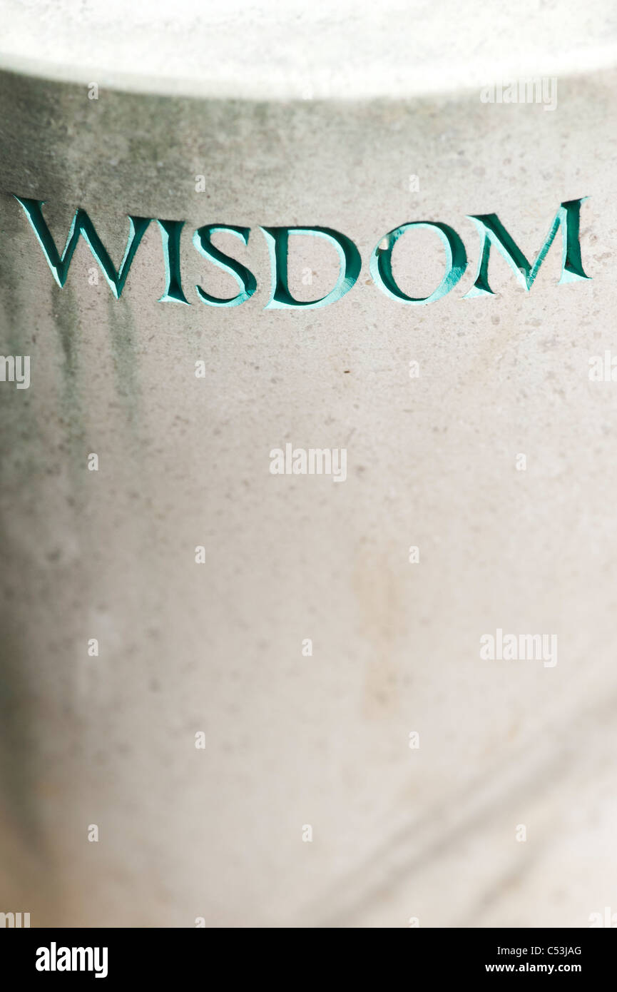 Wisdom carved on the plinth of a garden statue at Waterperry Gardens, Oxfordshire, England. Stock Photo