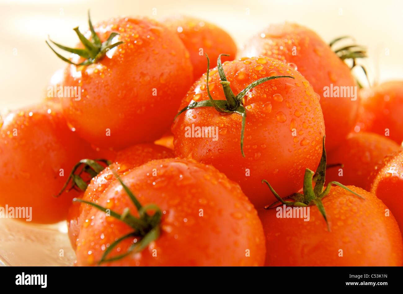 group of ripe tomatoes with droplets of water Stock Photo - Alamy