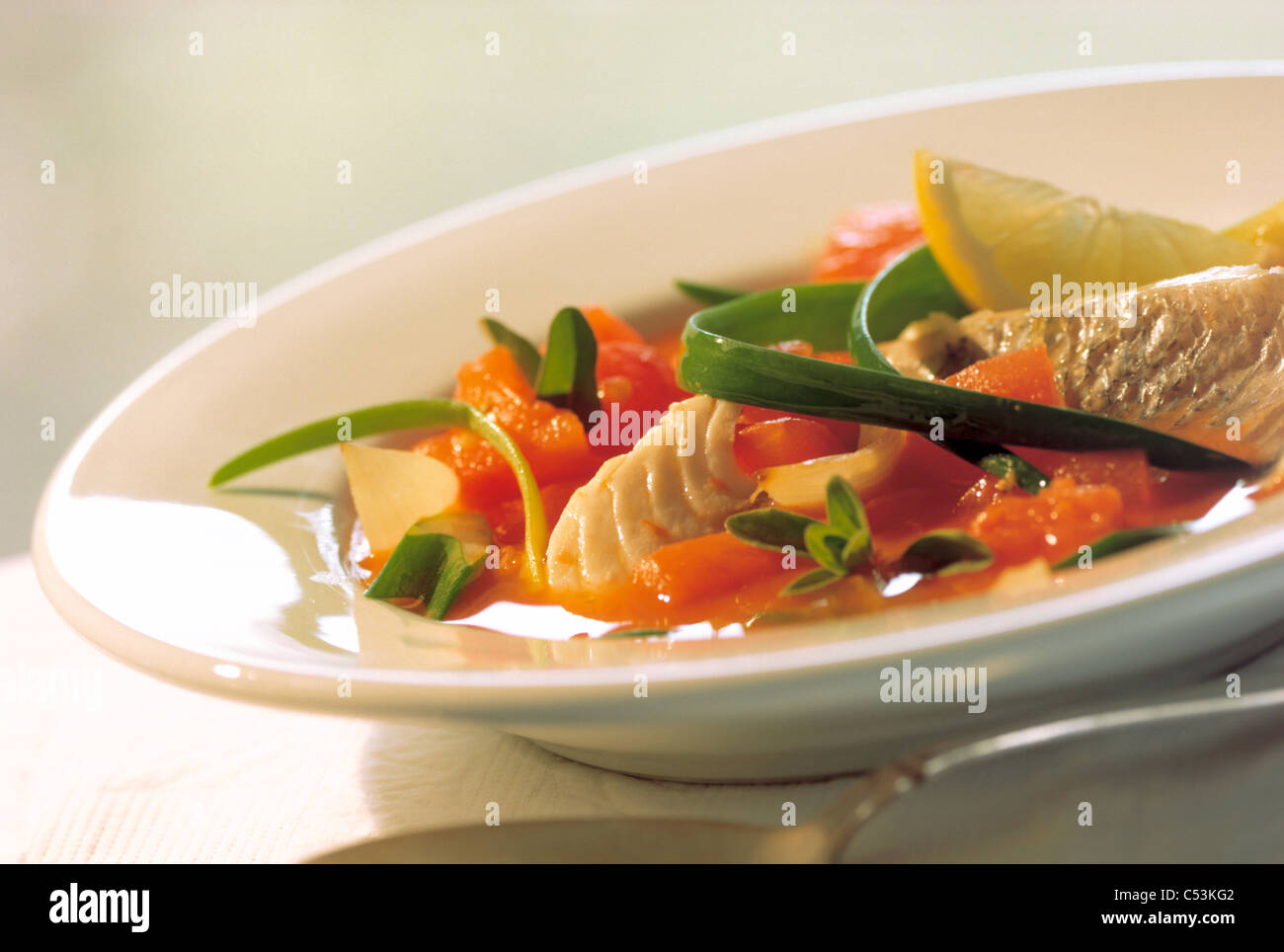 Tomato soup with spring onions, lemon and red barbel Stock Photo - Alamy