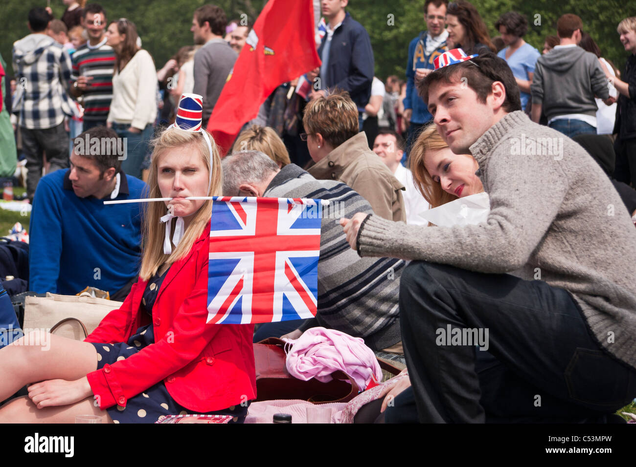 People celebrating the Royal Wedding in Hyde Park with Union Jack flags Stock Photo