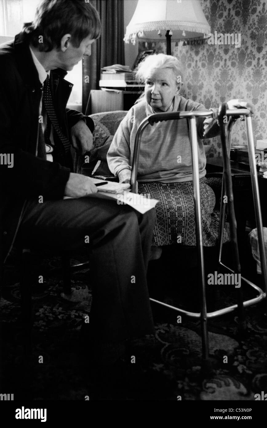 Doctor visiting an elderly patient in her home. Liverpool. UK. 1999 Stock Photo