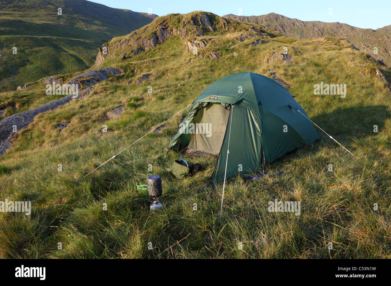 Tent in the Mountains with the Ridge Leading to Harter Fell From Nan Bield Pass Behind Lake District Cumbria UK Stock Photo