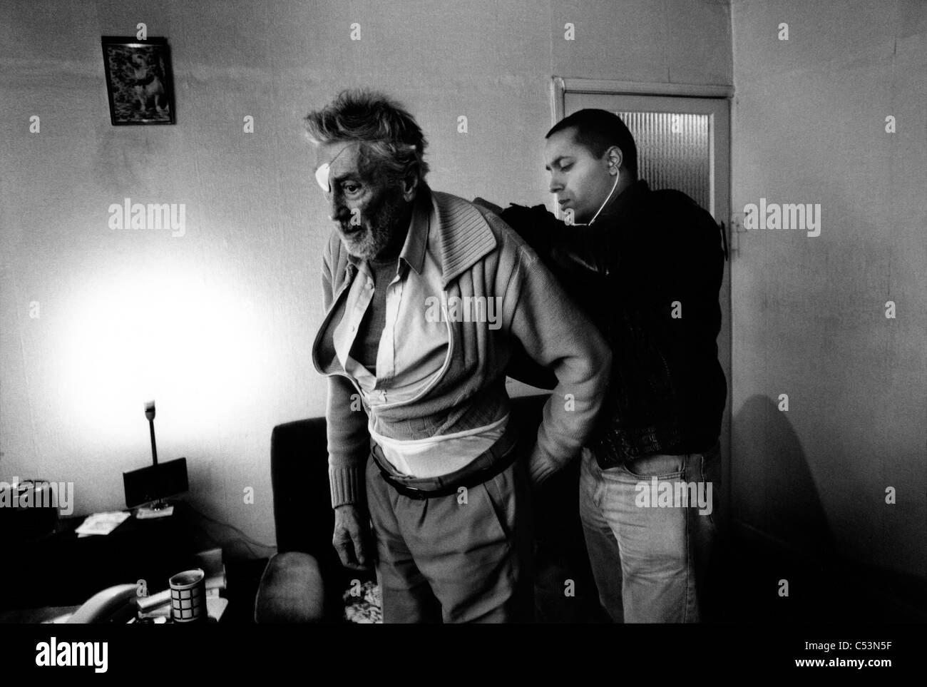 Doctor visiting a patient at home. Liverpool. UK. 1999 Stock Photo