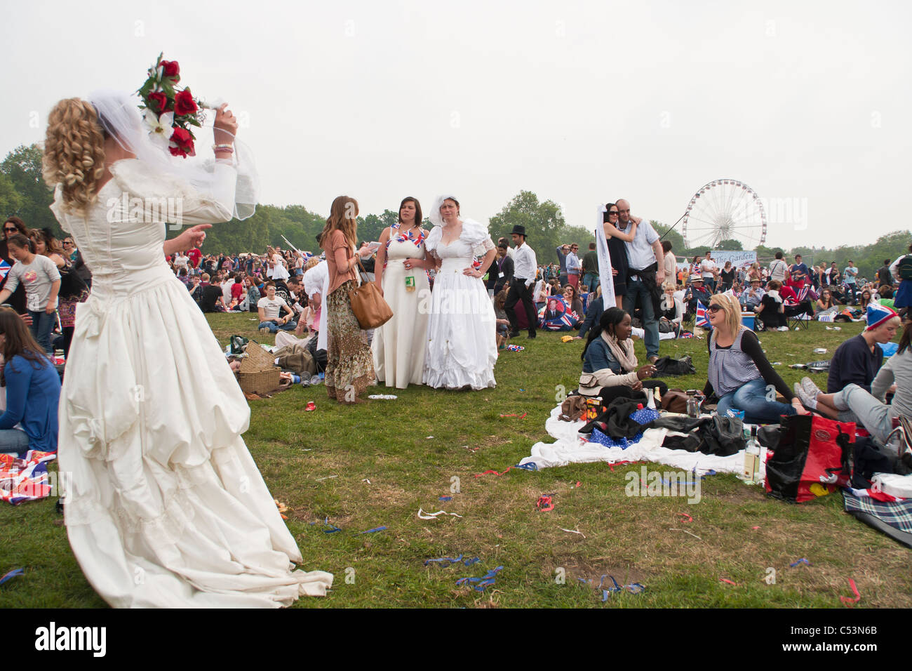 Girls dressed as brides celebrating the Royal wedding in Hyde Park. Stock Photo