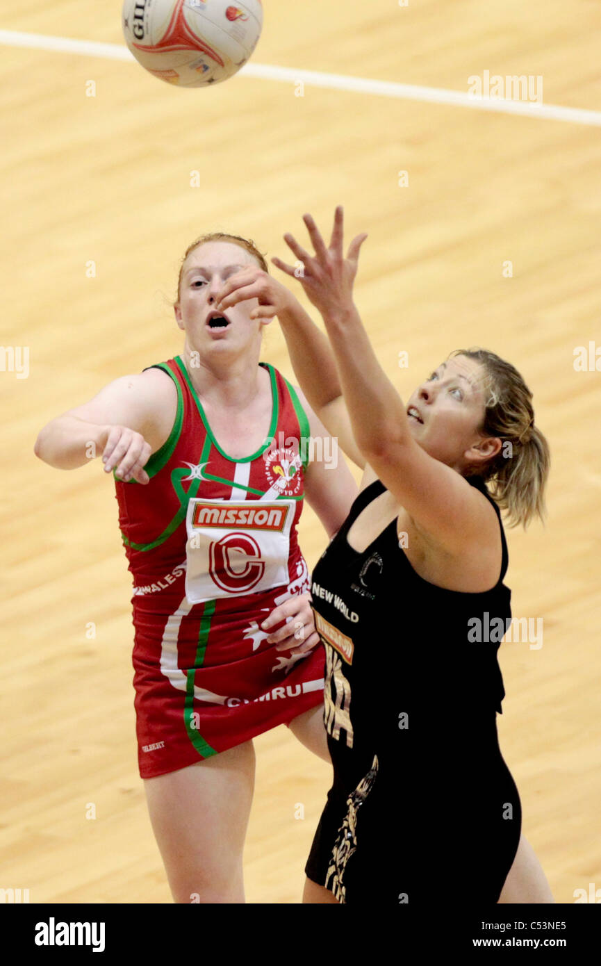 05.07.2011 Anna Thompson of New Zealand(black) battles with Sophie Baxter for the ball during the Pool B match between New Zealand and Wales, Mission Foods World Netball Championships 2011 from the Singapore Indoor Stadium in Singapore. Stock Photo