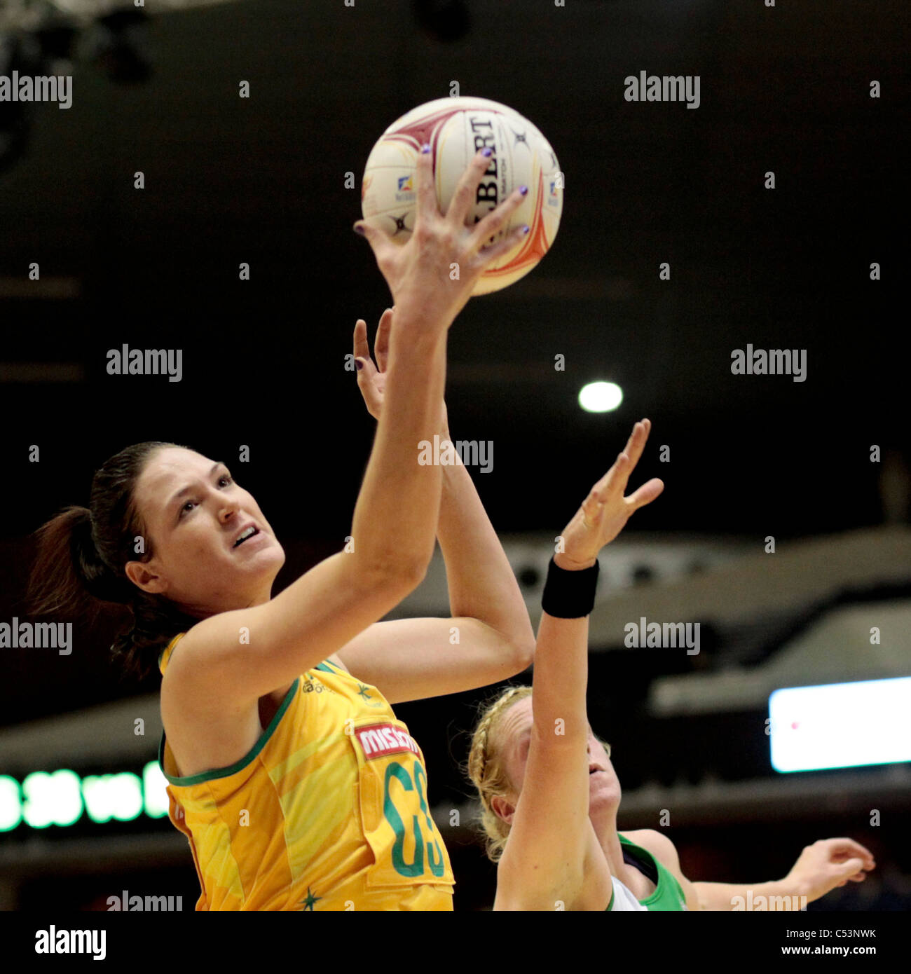 05.07.2011 Caitlin Bassett of Australia(left) battles with Gemma Gibney of Northern Ireland for the ball during the Pool A match between Australia and Northern Ireland, Mission Foods World Netball Championships 2011 from the Singapore Indoor Stadium in Singapore. Stock Photo