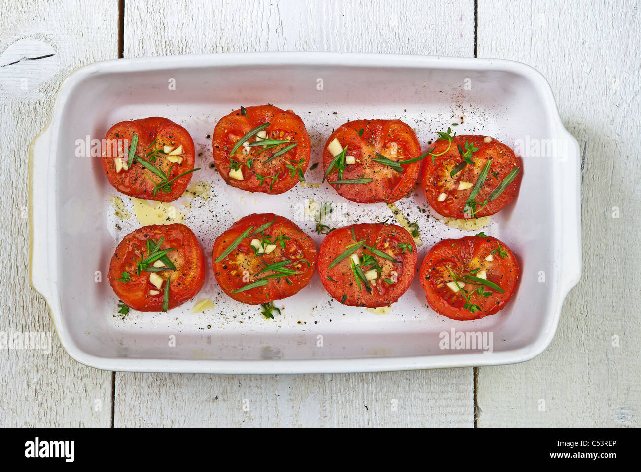 baked tomatoes in a white casserole Stock Photo