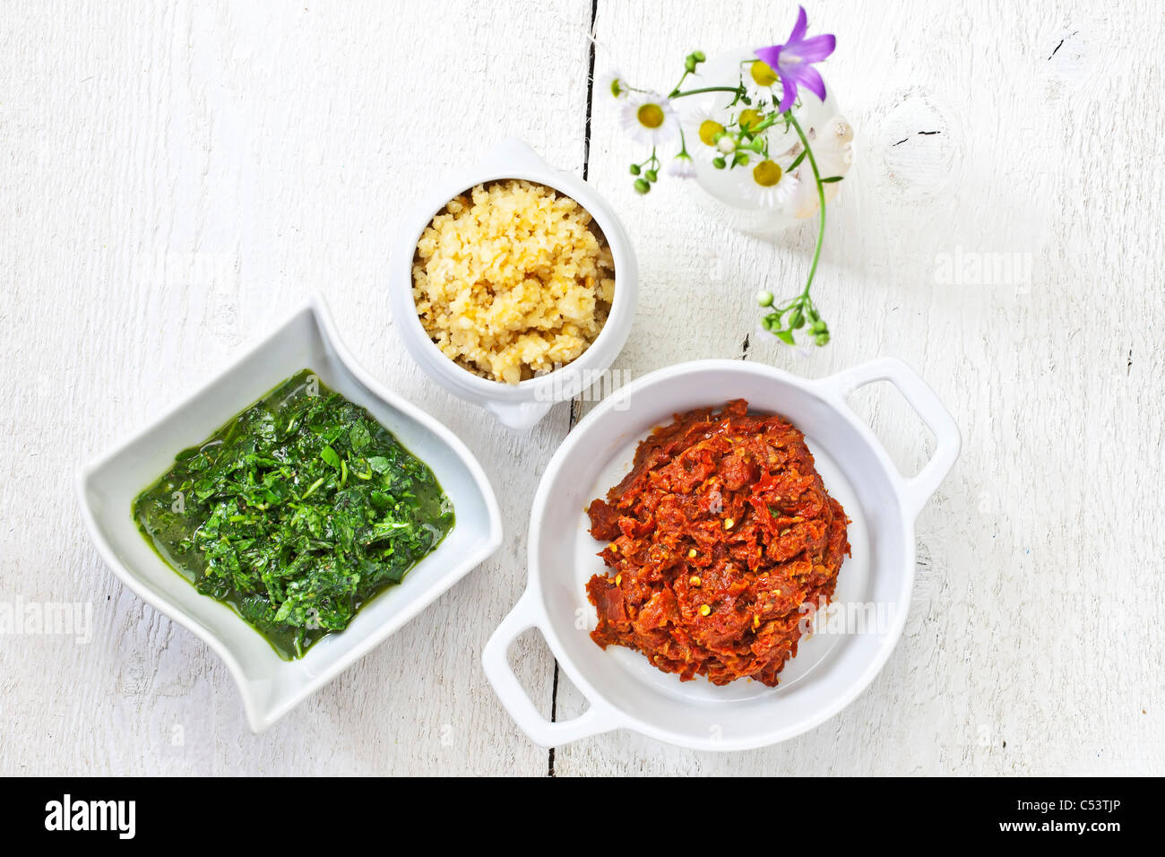 Pesto with the national colors of Italy - consisting of rocket and basil pesto, cheese and pine nuts and dried tomatoes Stock Photo
